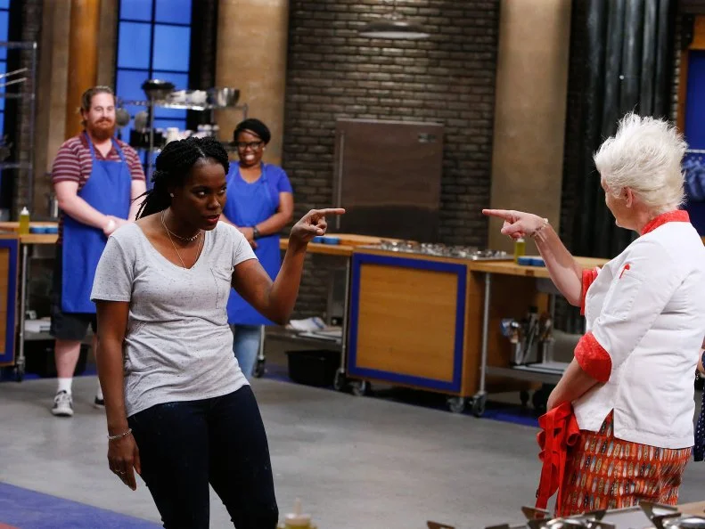 Brittany Moore of the red team jokes with mentor Anne Burrell after being eliminated, as seen on Food Network's Worst Cooks in America, Season 10.