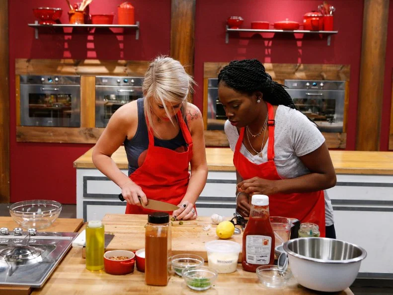 Mandy Thornton and Brittany Moore of the red team cook while attempting to recreate Fried Green Tomato with Remoulade and Barbecue Shrimp during the skill drill challenge, as seen on Food Network's Worst Cooks in America, Season 10.