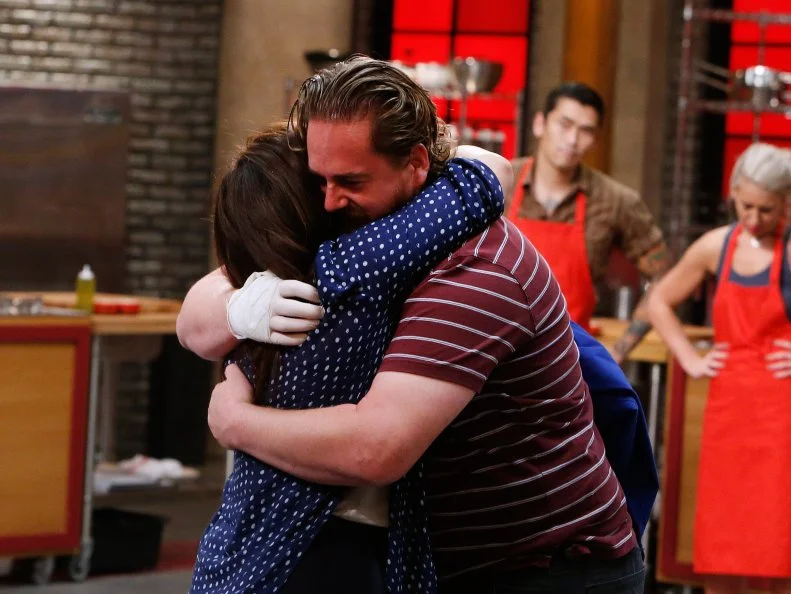 Adam Cooke of the blue team hugs mentor Rachael Ray after being eliminated, as seen on Food Network's Worst Cooks in America, Season 10.
