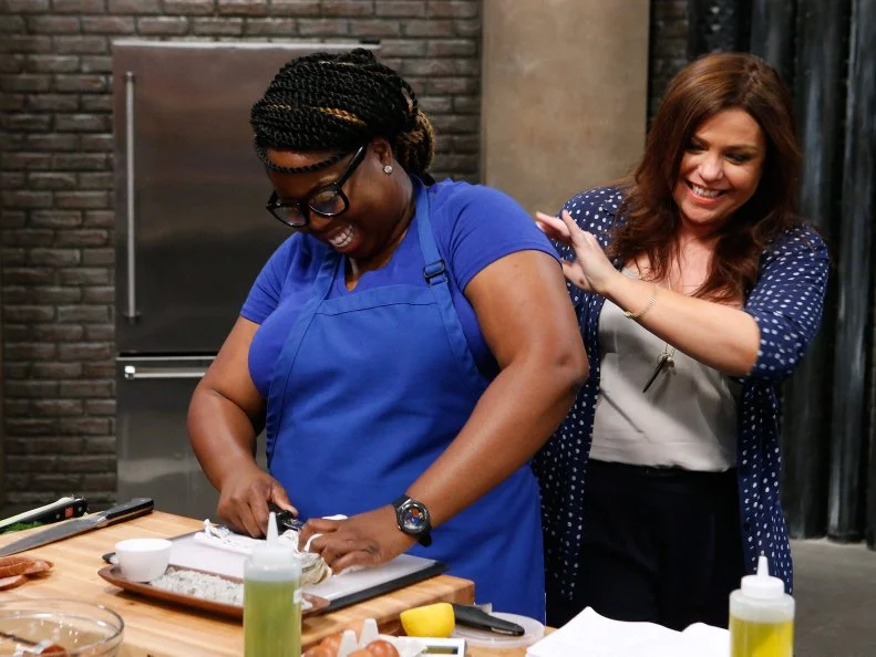 Mentor Rachael Ray checks in on Ann Odogwu of the blue team as she cooks during the main dish challenge, as seen on Food Network's Worst Cooks in America, Season 10.