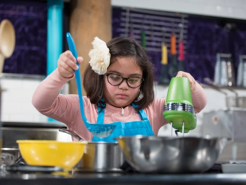 Junior contestants Olivia Acosta cooks Dessert burger with a French toast bun during the dessert round, as seen on Food Network's Chopped Junior, Season 6.
