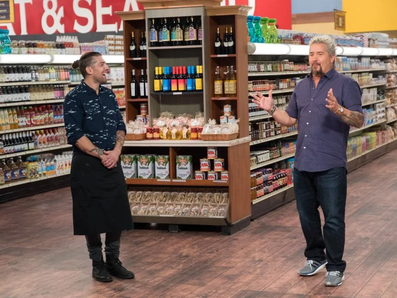 Contestant Samuel Monsour smiles as Host Guy Fieri announces that he is the winner, as seen on Food Network's Guy's Grocery Games, Season 12.