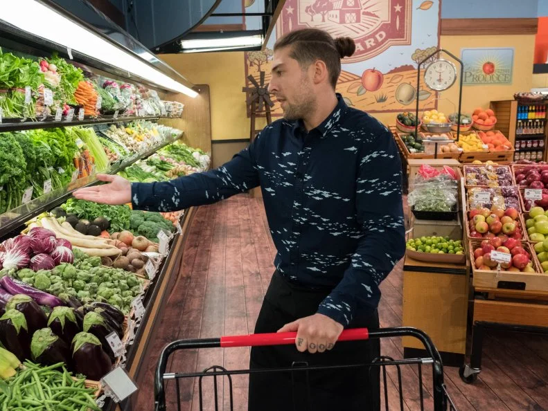 Contestant Samuel Monsour shops for vegetables during the ABC game, as seen on Food Network's Guy's Grocery Games, Season 12.