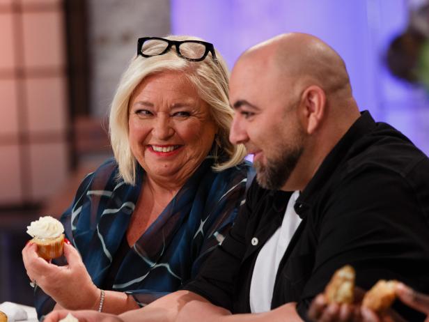Judges Duff Goldman (r.) and Nancy Fuller (l.) interact with one another as they critique a sweet-and-savory-themed trio of desserts including bacon jalapeno cornbread, apple pie cupcakes, and salted caramel white chocolate blondie prepared by Daniela Copenhaver during the pre-heat challenge as seen on Food Network's Spring Baking Championship, Season 3.