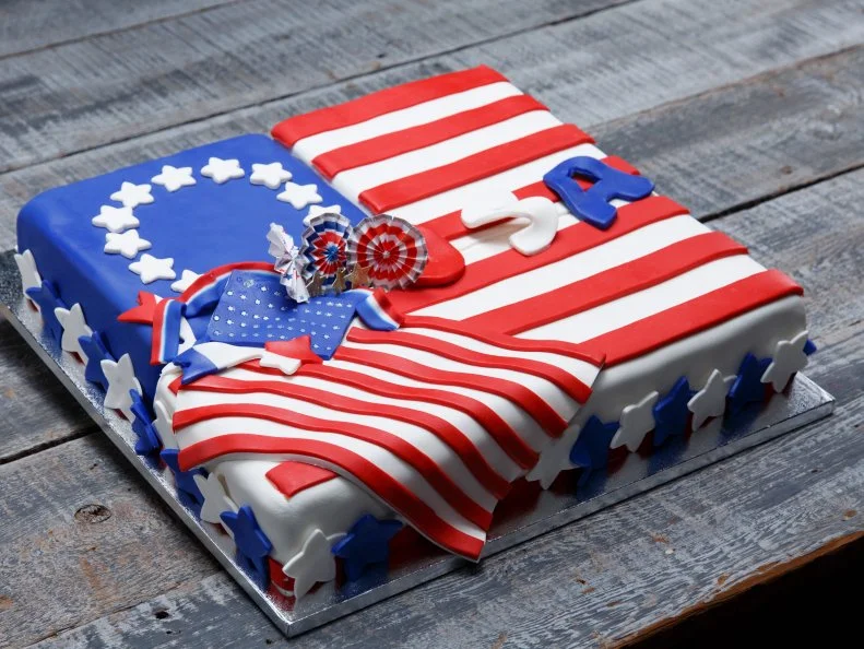 A flags-themed Banana pound cake with swiss buttercream filling and caramelized bananas prepared by Jordan Pilarski, as seen on Food Network's Spring Baking Championship, Season 3.