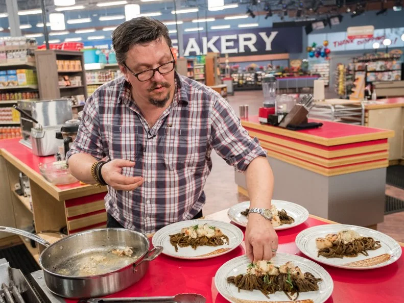 Contestant Tom Ramsey puts the finishing touches on his dish, as seen on Food Network's Guy's Grocery Games, Season 12.
