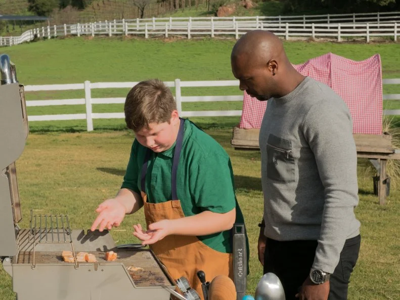 Host Eddie Jackson talks to contestant Jacob Van Ry, as seen on Kids BBQ Championship, Season 2.