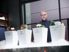 Host Alton Brown revealing the Chairman's Challenge, as seen on Iron Chef Gauntlet, Season 1