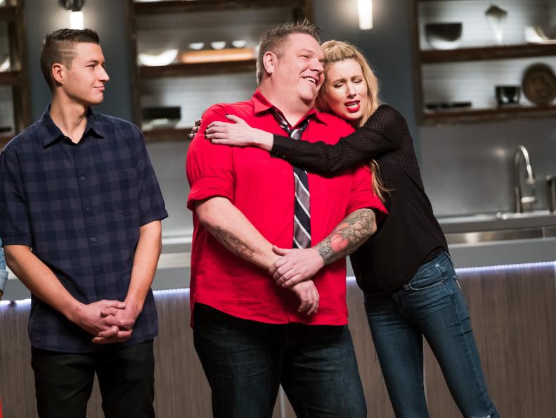 Contestants Matthew Grunwald, Rob Burmeister and Danushka Lysek reacting to Rob's elimination for the Mentor Challenge Passing the Bar, as seen on Food Network's Comeback Kitchen, Season 2.