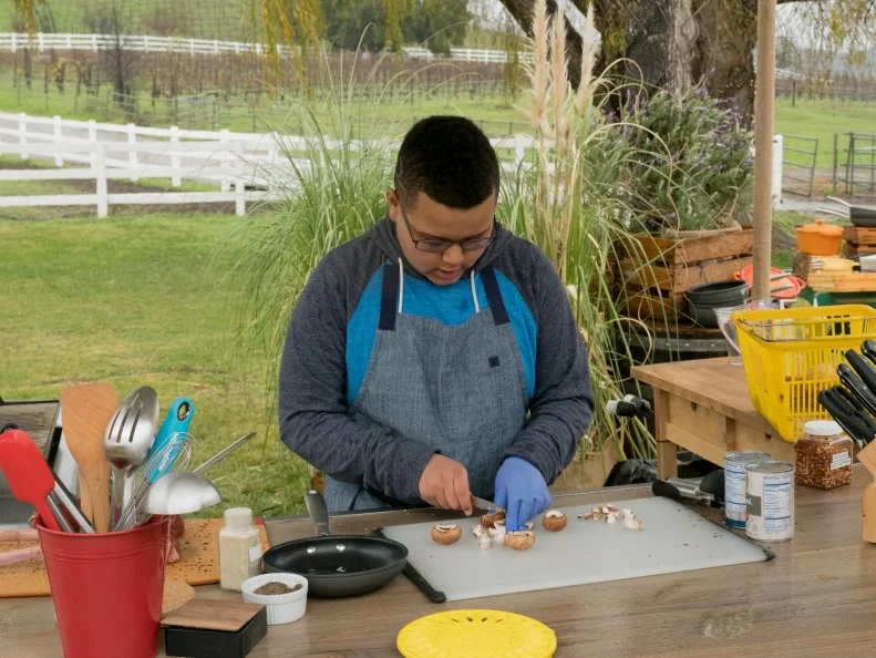 Contestant Kody Roberts cuts mushrooms for his Cowboy Steak, as seen on Kids BBQ Championship, Season 2.