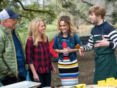 Guest Judges Andrew Zimmerman, Melissa d'Arabian and Host Giada de Laurentiis check in with Contestant Trace Barnett preparing his dish, Rustic Vegetable Soup served in a Grilled Pepper, for the Star Challenge Camping to Glamping, as seen on Food Network Star, Season 13.