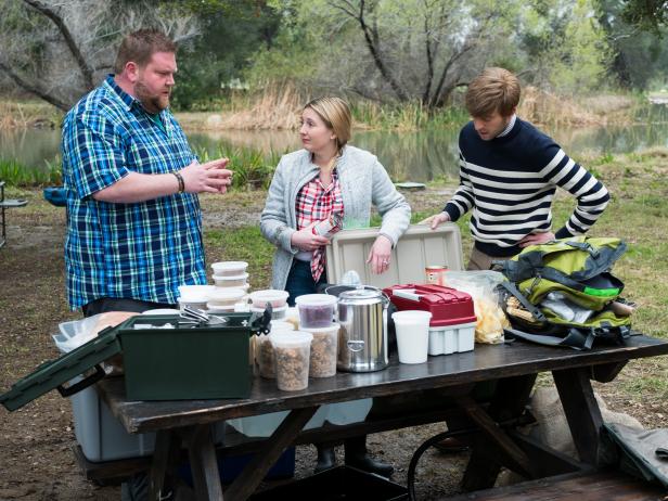 Contestants Rusty Hamlin, Addie Gundy and Trace Barnett sorting through their ingredients for the Star Challenge Camping to Glamping, as seen on Food Network Star, Season 13.
