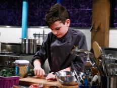 Junior chef Buck Milligan cooks with earthworm jerky, tomato candy, baby kale and ground camel during the appetizer round, as seen on Chopped Junior, Season 7.