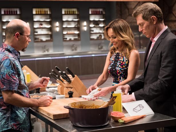 Contestant Jason Smith presents his dish, Osso Bucco Wrap, to Hosts Bobby Flay and Giada Da Laurentiis for the Mentor Challenge Slow-Cooked Flavors Fast, On The Go, as seen on Food Network Star, Season 13.