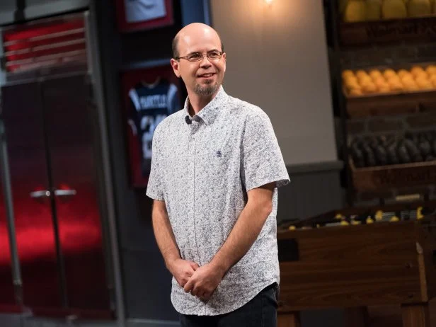 Contestant Jason Smith watching his tv segment for the Star Challenge ESPN Game Day, as seen on Food Network Star, Season 13.