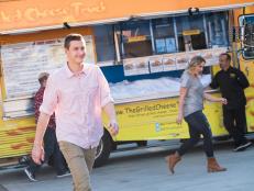 Contestants Matthew Grunwald, Jason Smith and Amy Pottinger heading to their designated food trucks for th Mentor Challenge Live TV – Food Trucks, as seen on Food Network Star, Season 13.