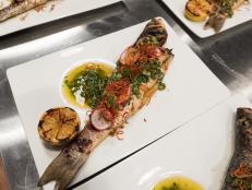 Contestant Cory Bahr's dish, Whole Roasted Fish, Green Tomato and Herb Vinaigrette and Charred Lemon, for the Star Challenge Cook For Your Life, as seen on Food Network Star, Season 13.