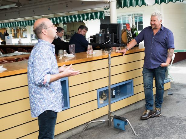 Guest Judge Guy Fieri directing Contestant Jason Smith filming his Pilot at the Farmers Market, as seen on Food Network Star, Season 13.