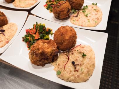 Contestant Rusty Hamlin's dish, Crawfish Boudin Balls, Andouille Grits and Collard Green Chow Chow, for the Star Challenge Cook For Your Life, as seen on Food Network Star, Season 13.