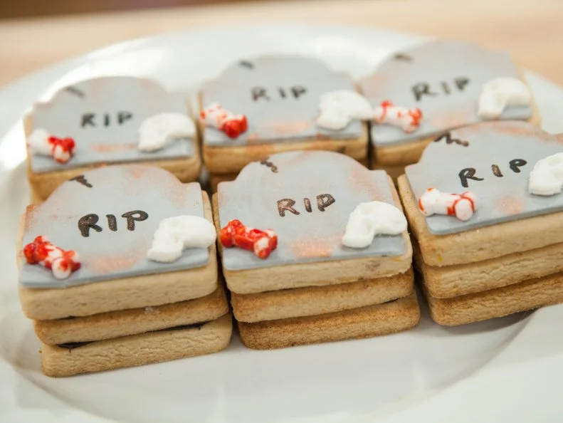 Andrea Kratville's TOMBSTONE themed cinnamon orange vanilla sugar cookie filled with candy bones, as seen on Halloween Baking Championship, Season 3.