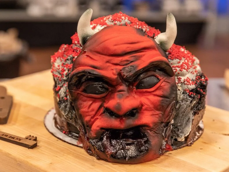 Contestant Brenda Villacorta's completed dish from the main heat challenge, Dark chocolate cake with sesame milk chocolate ganache and buttercream, as seen on Food Network's Halloween Baking Championship, Season 4.