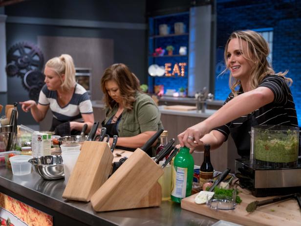 Contestants Sarah Penrod, Debbie Lee and Amy Pottinger in the kitchen preparing their dish during the Vintage Food Challenge, as seen on Comeback Kitchen, Season 3.