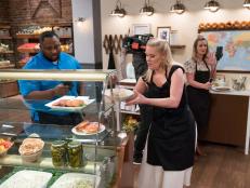 Contestants Jernard Wells, Sarah Penrod and Amy Pottinger in the kitchen during the Deli Instagram Challenge, as seen on Comeback Kitchen, Season 3.