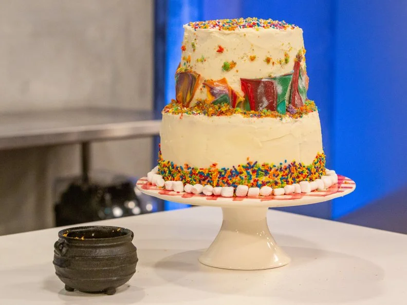 Contestant Matthew Azuma's completed dish from the main bake, Rainwbow lemon cake with raspberry filling, raspberry buttercream, and lemon buttercream, as seen on Kids Baking Championship, Season 5.