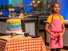 Contestant Natasha Jiwani presents her dish from the main bake to the judges, as seen on Kids Baking Championship, Season 5.