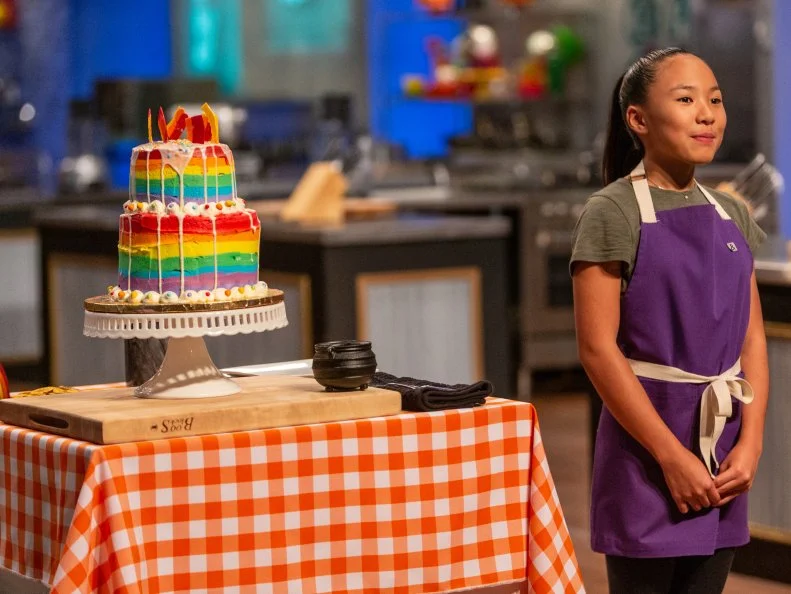 Contestant Taylor Inouye presents her dish from the main bake to the judges, as seen on Kids Baking Championship, Season 5.
