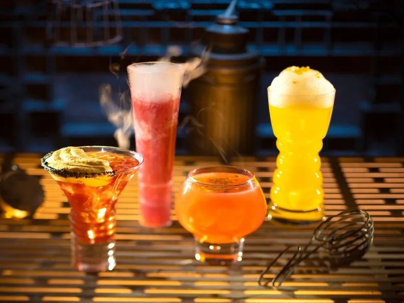 Guests will discover innovative and creative concoctions from around the galaxy at Star Wars: Galaxy's Edge at Disneyland Park in Anaheim, California and at Disney's Hollywood Studios in Lake Buena Vista, Florida. From left to right, alcoholic beverages: The Outer Rim, Bespin Fizz, Yub Nub, and Fuzzy Tauntaun can be found at Oga's Cantina. (Kent Phillips/Disney Parks)