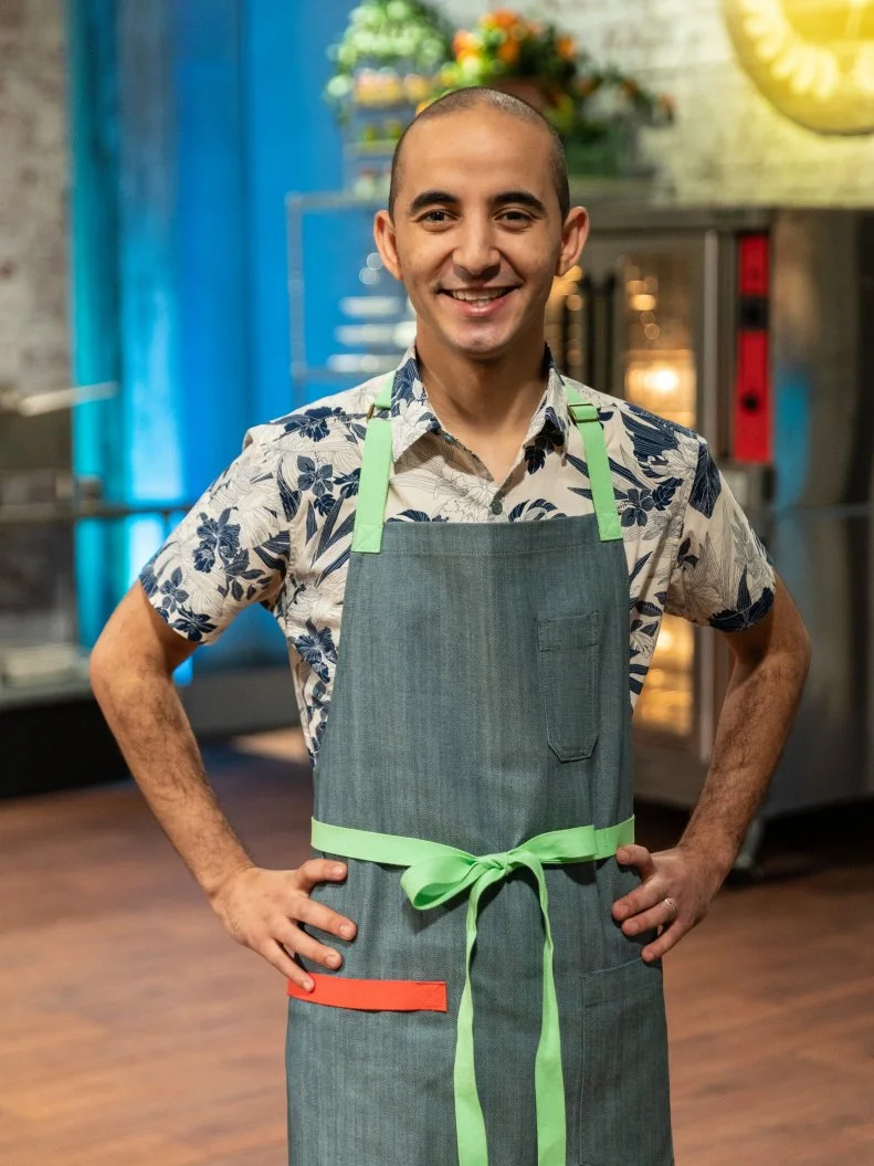 Contestant Saber Rejbi poses for a photo, as seen on Spring Baking Championship, Season 5.