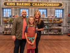 Hosts Valerie Bertinelli and Duff Goldman pose for a photo with winner Paige Goehner, as seen on Kids Baking Championship, Season 6.