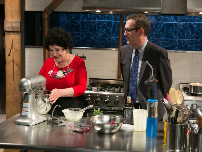 Chopped host Ted Allen checks in on amateur chef Elda Bielanski as she works on her dessert that must include: cookie spread, creme anglaise, grapefruit and microwave mug cupcakes as she competes for a slot in the Chopped Ultimate Championship competition, the winner of which receives $50,000 and a new car from Buick, as seen on Food Network's Chopped, Season 21.