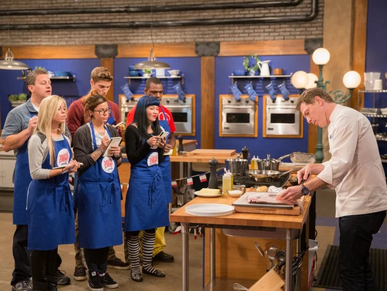 Host Bobby Flay addresses his team on set as seen on Food Networkâ  s Worst Cooksin America, Season 5.
