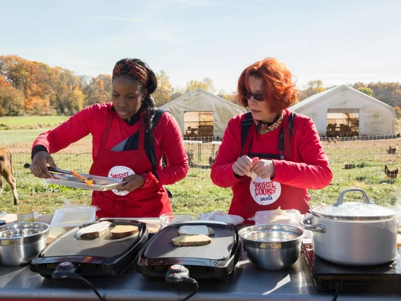 Contestants Stephanie Saint Aubin and Carol Holder duringa cooking challenge on Cherry Grove Farm as seen on Food Networkâ  s Worst Cooksin America, Season 5.