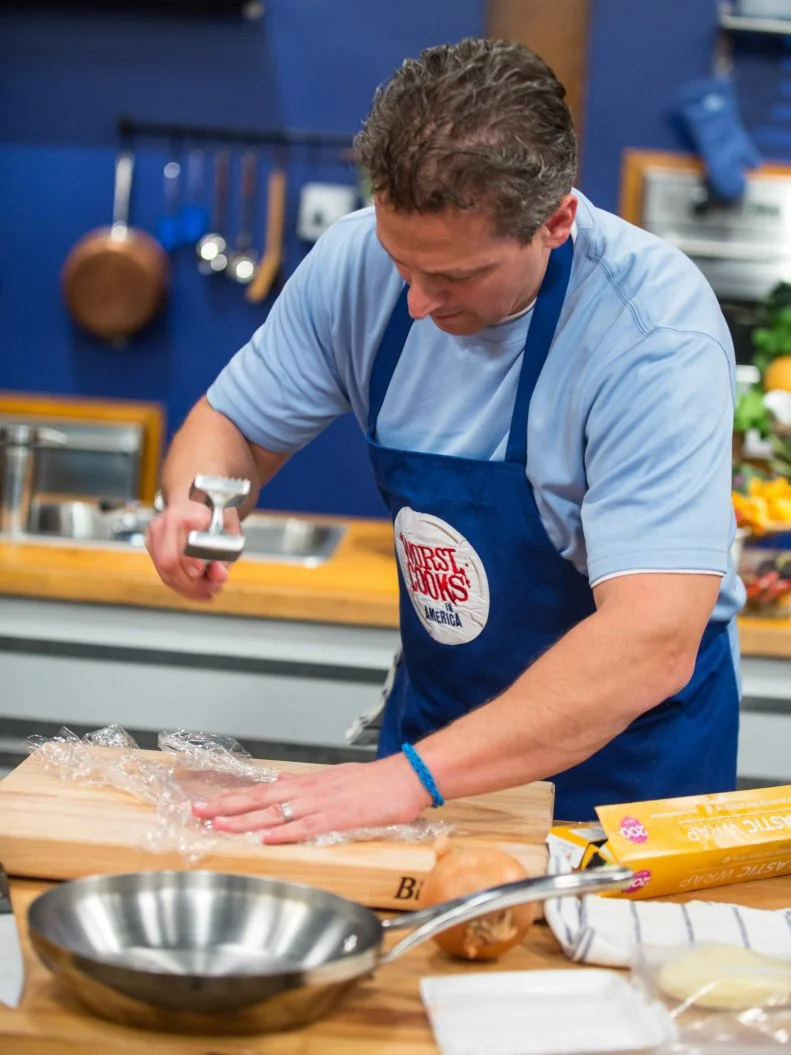 Daniel Beyda tenderizes meat for the Roulade Challenge as seen on Food Network's Worst Cooks in America, Season 5.