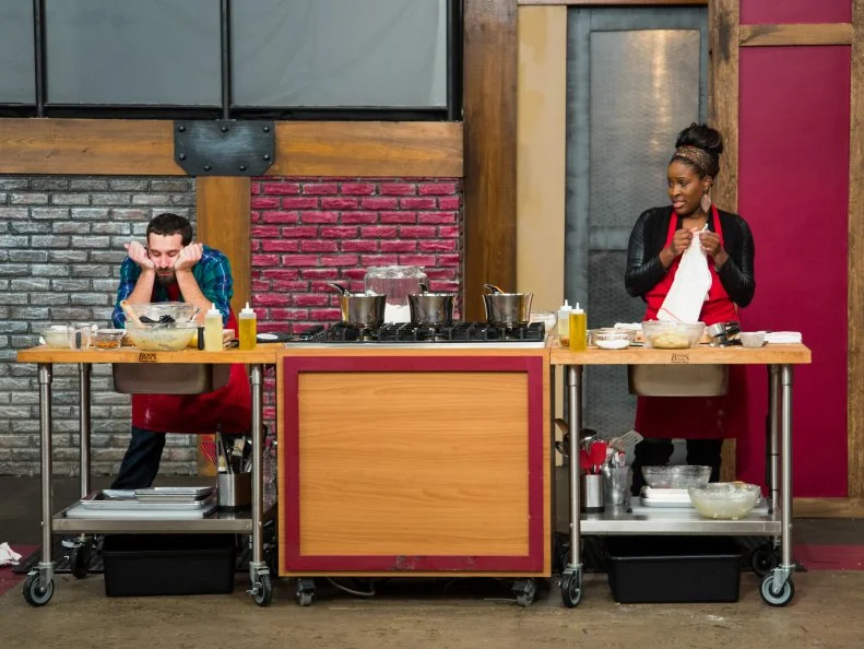 Mike Glazer of the Red Team waits for his dough to rise while Stephanie St. Aubin looks on for the Donut Challenge as seen on Food Network's Worst Cooks in America, Season 5.