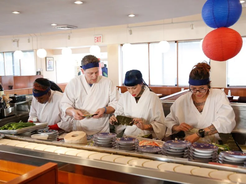 The Blue Team races to beat the clock during the Sushi Skill Drill Challenge. The Red and Blue team recruits must prepare two sushi dishes for a hungry lunchtime crowd and are tested on both their time & quantity: A California Roll with snow crab, nori, rice on the outside, garnished with sesame seeds and a Salmon Roll with sliced salmon, scallion, sushi rice, spicy mayo (with nori on the outside.)  The diners will determine which team will the challenge, as seen on Food Network's Worst Cooks in America, Season 5.