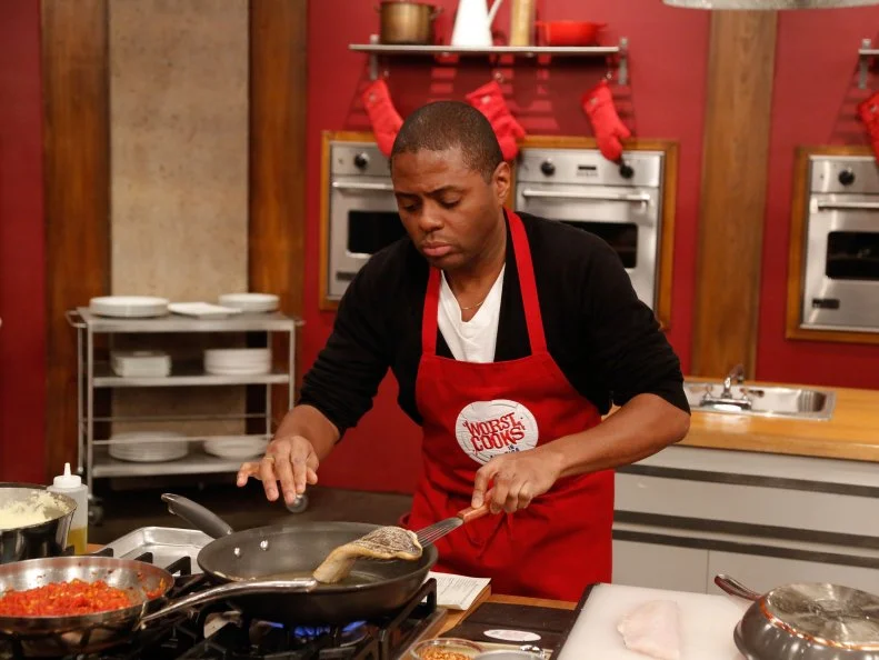 Red Team recruit Jamie Thomas races to complete his dish for his loved one, during the Feed the Family Challenge. Red Team recruit Jamie Thomas has to prepare Red Team Leader Chef Anne Burrell's Black Bass with Piperade and Polenta, as seen on Food Network's Worst Cooks in America, Season 5.