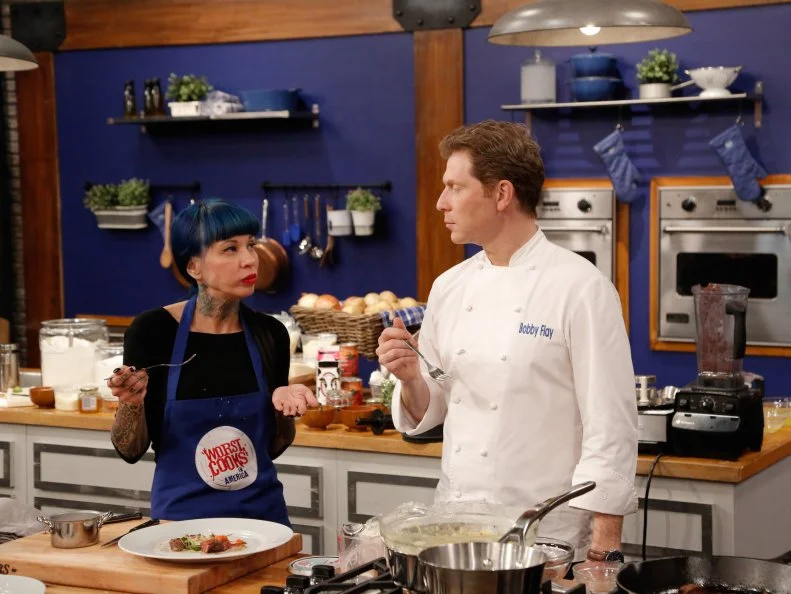 Blue Team recruit Amber Brauner waits while Blue Team Leader Chef Bobby Flay and Red Team Leader Chef Anne Burrell taste her Bison Tenderloin with Piquillo Pepper Pesto and Tapenade Mashed Potatoes, which she will prepare for the final challenge, where the recruits compete in a final cook-off before a panel of distinguished guests for the chance to win $25,000, as seen on Food Network's Worst Cooks in America, Season 5.