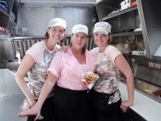 Team Military Moms' Wendy Newman, Carol Rosenberg and Michele Bajakian pose for the camera with a "Sergeant Cheezy" sandwich,  as seen on Food Network's The Great Food Truck Race, Season 5.