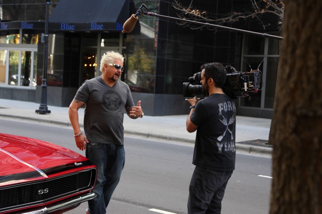 Behind the scene shot of film crew filming Guy Fieri doing the stand up outside of Mert's Heart and Soul in Charlotte, NC seen on Food Network's Diners, Drive-Ins and Dives.
