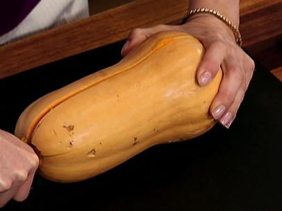 Female hands making butternut squash noodles with a vegetable peeler.Top  view Stock Photo - Alamy