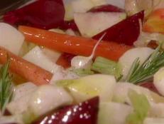 Serve Food Network's Roasted Root Vegetable Medley recipe, which includes carrots, beets, parsnips, turnips and potatoes, alongside a meaty main.