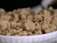 The crumbled toppig is placed on the peach and blueberry dish.