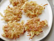 A plate of potato latkes fried until golden brown.