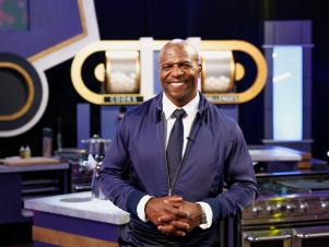 Host Terry Crews posed in kitchen, as seen on 100 Cooks, Season 1.