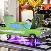 Host Duff Goldman’s automotive inspired birthday cake for guest judge Richard Rawlings at the Peterson Automotive Museum in Los Angeles, as seen on Buddy vs Duff, Season 1
